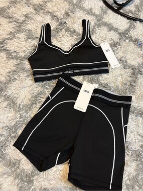 ALO Yoga Black Sports Bra and High-Waist Shorts with White outline brand new .